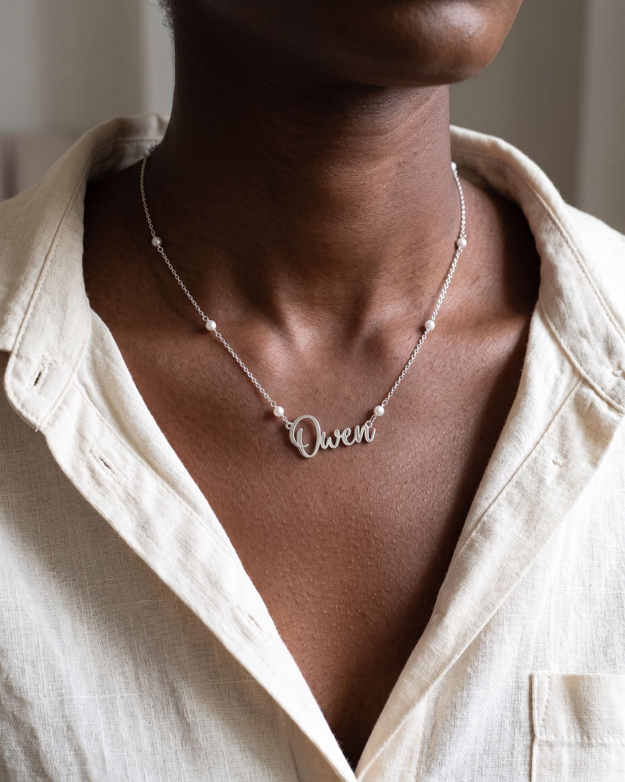 Model Image - Personalized name necklace with script pendant and pearl satellite chain detail worn on model
