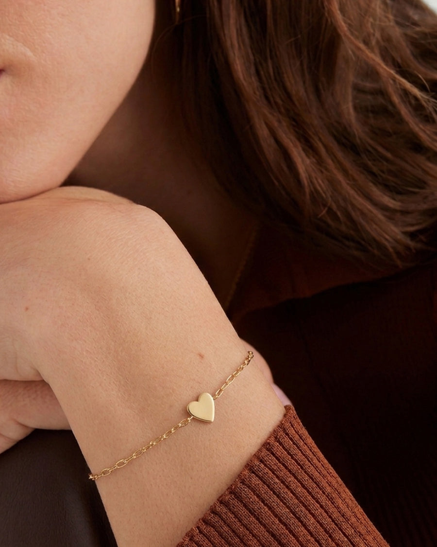 Style Image - 14k solid gold heart bracelet worn on the wrist with a delicate chain and heart-shaped pendant