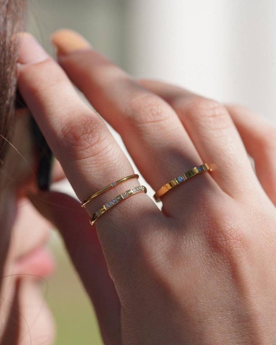 Style Image - Stackable ring set worn across fingers, showing slim gold plated stainless steel bands in layered styling