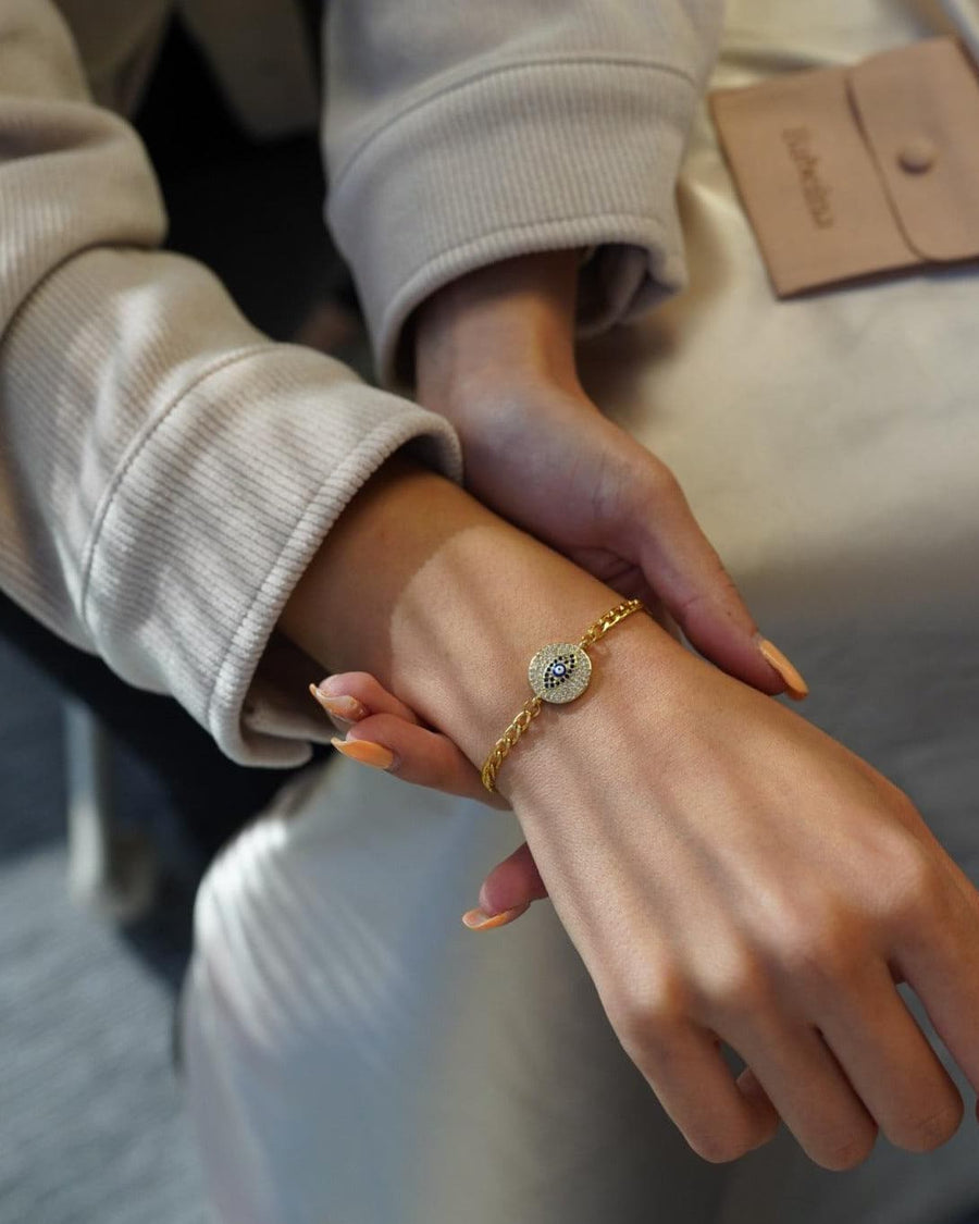 Style Image - Evil Eye Bracelet worn on the wrist with a gold-plated chain and round evil eye charm