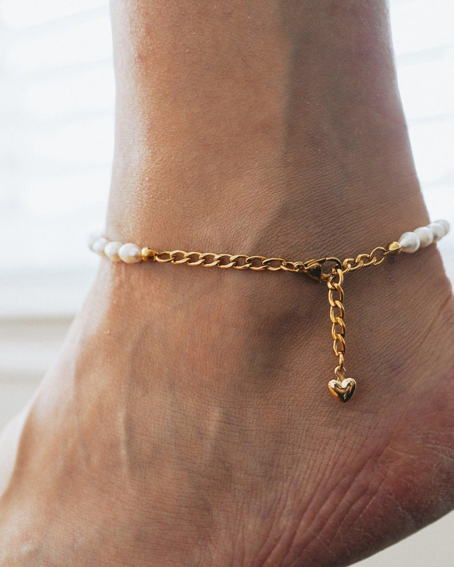 Model Image - Pearl anklet with gold plated stainless steel chain, white pearls, extender, and heart-shaped charm worn on model