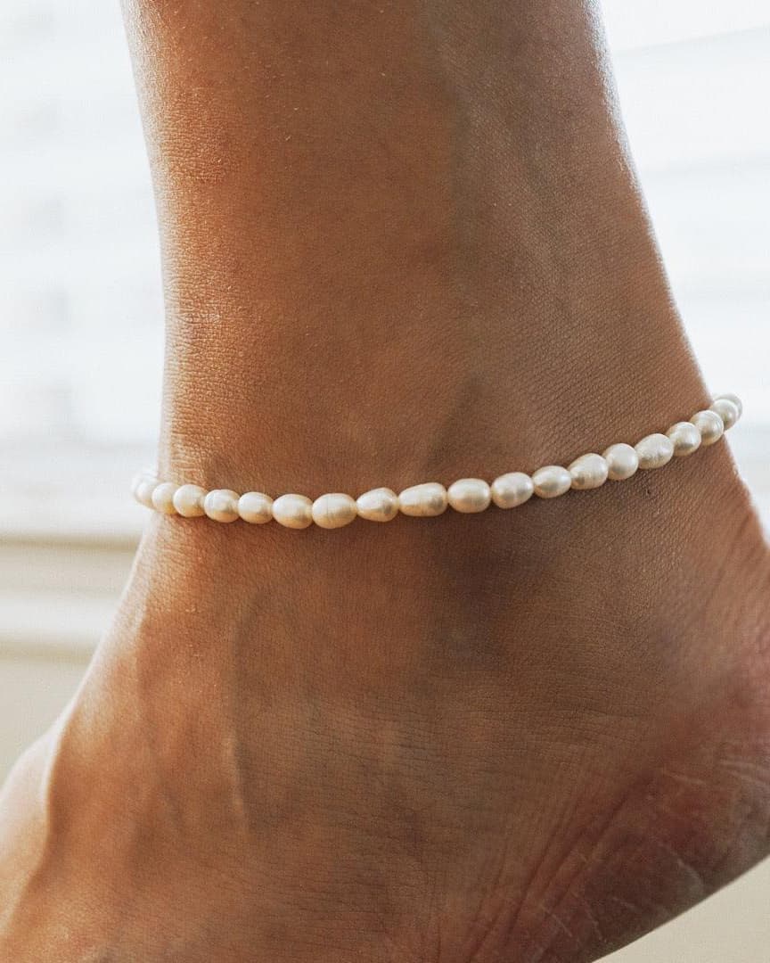 Style Image - Pearl anklet worn around the ankle, showing a delicate strand of pearls in a close-up view