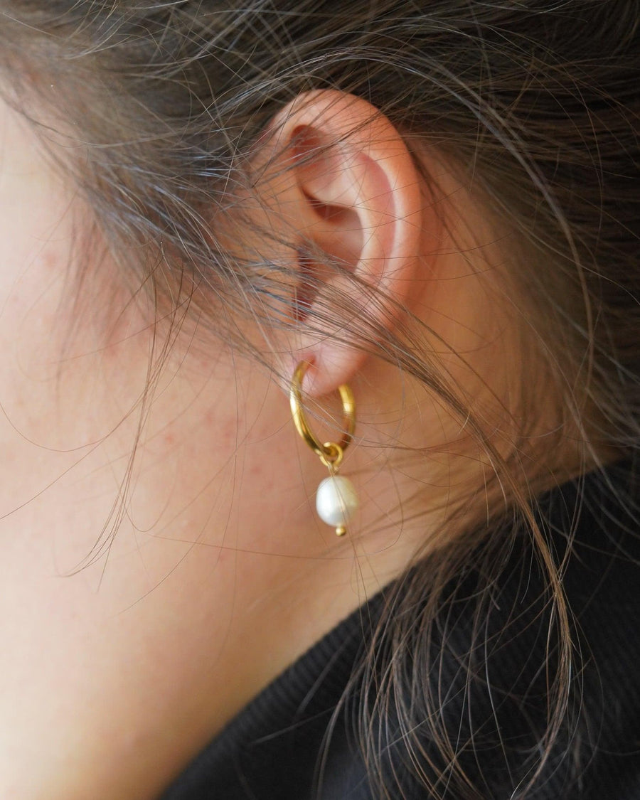 Style Image - Pearl hoop earring worn on the ear with a delicate huggie design
