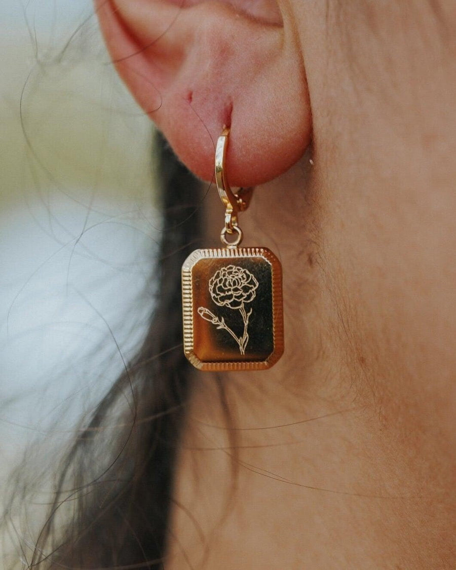 Style Image - Square birth flower earring in 18k gold plated stainless steel worn on the ear with a floral pendant design.
