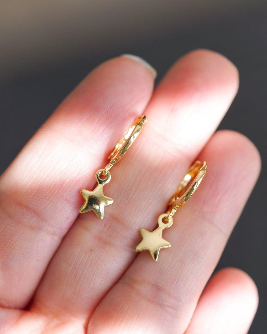 Detail Image - Star earrings with small star charms shown close up on fingertips