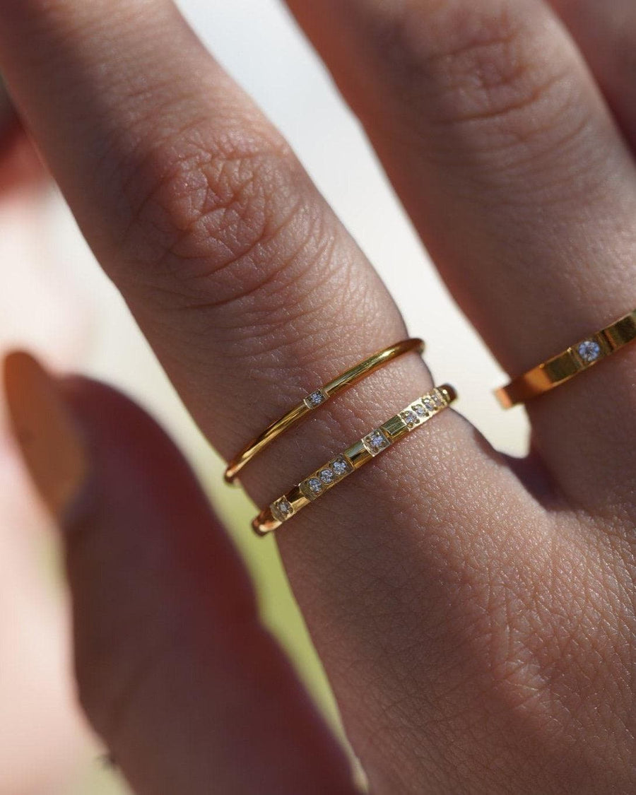 Model Image - single stackable ring styled with other rings on a model’s hand worn on model
