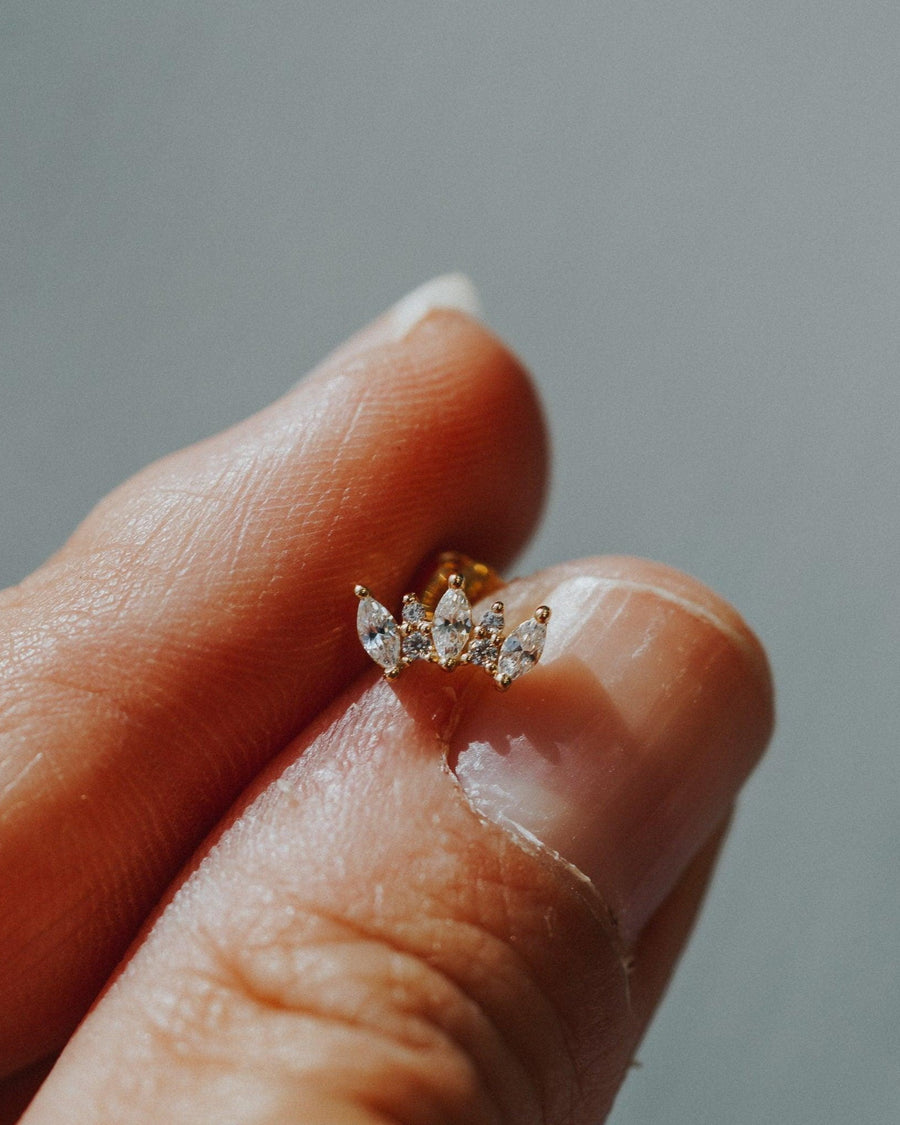 Detail Image - Marquise Tiara Stud with white zircon stones in 14k yellow gold held between fingertips