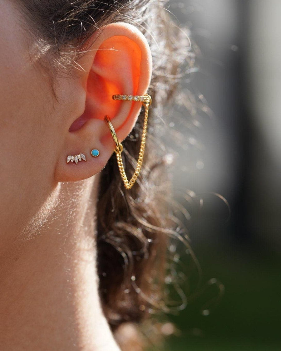 Model Image - Marquise Tiara Stud earring styled on the earlobe with additional earrings and a chain ear accent worn on model