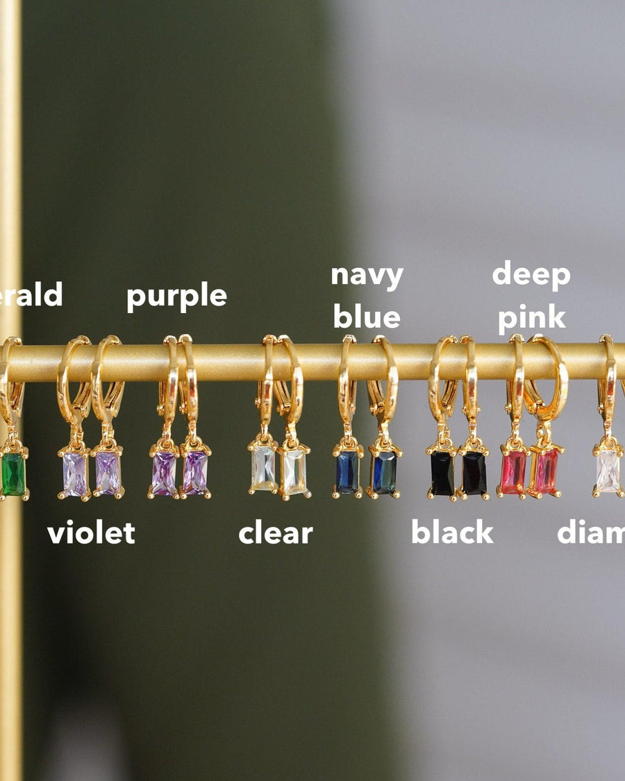 Style Image - Zircon earrings displayed on a gold-tone bar with color labels including violet, clear, navy blue, black, and deep pink