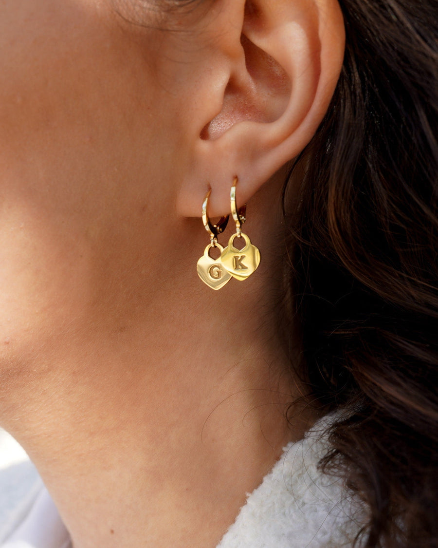 Style Image - Engravable heart drop earrings with initial charms worn on the ear