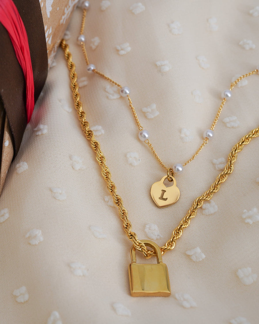 Model Image - Initial Lock Layering Set necklace with two layered lock pendants and pearl bead and rope chains worn on model