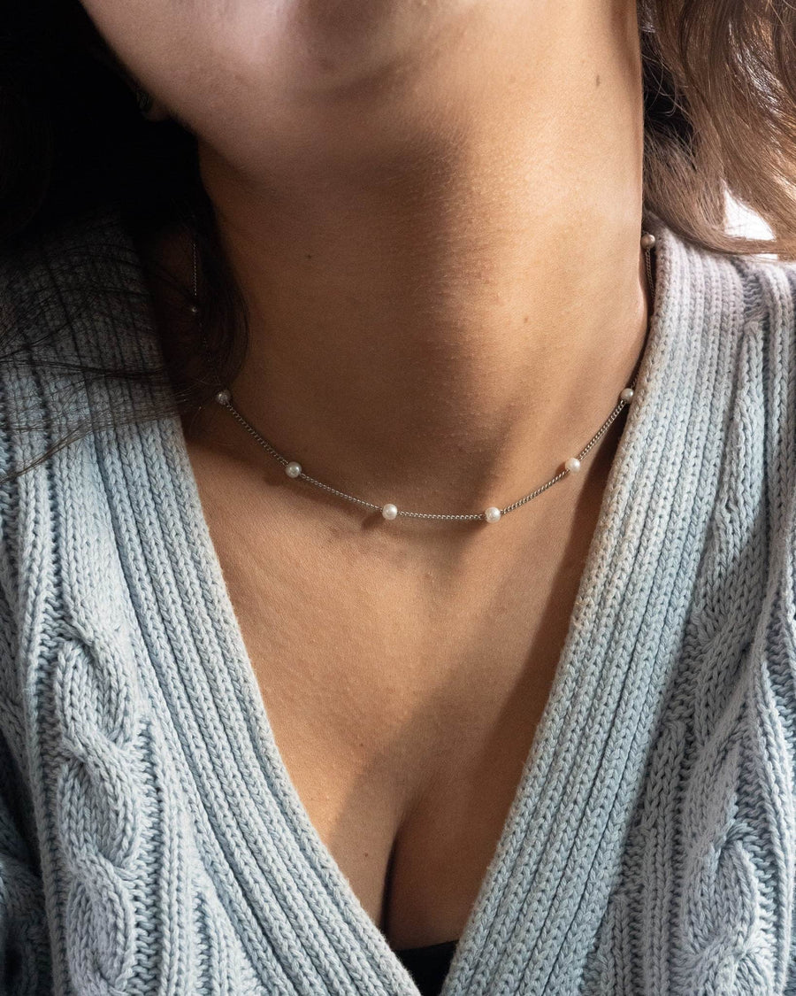 Model Image - Satellite pearl chain necklace in silver with delicate pearl beads at the neckline worn on model