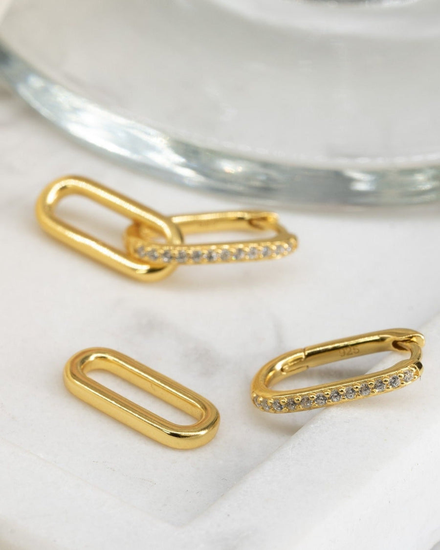 Detail Image - Pave Link Hoops in 14K gold plated interlocking link design with pave sparkle on a marble surface