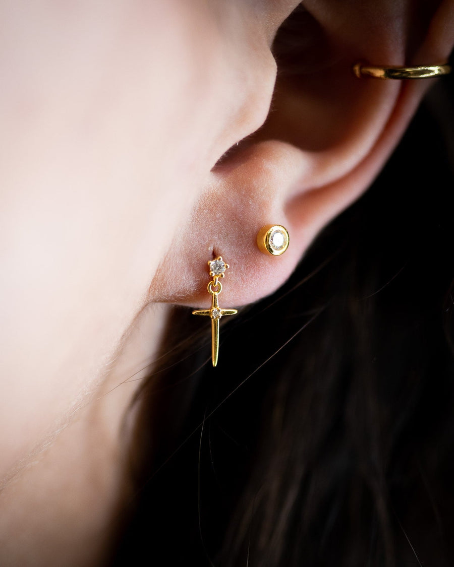 Style Image - Cross Drop Stud worn in an ear stack with other gold-tone earrings
