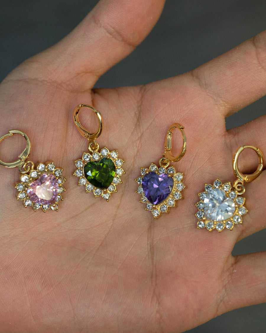 Model Image - Queen Heart Earrings with heart-shaped crystal halo pendants in assorted gemstone colors displayed on a hand worn on model