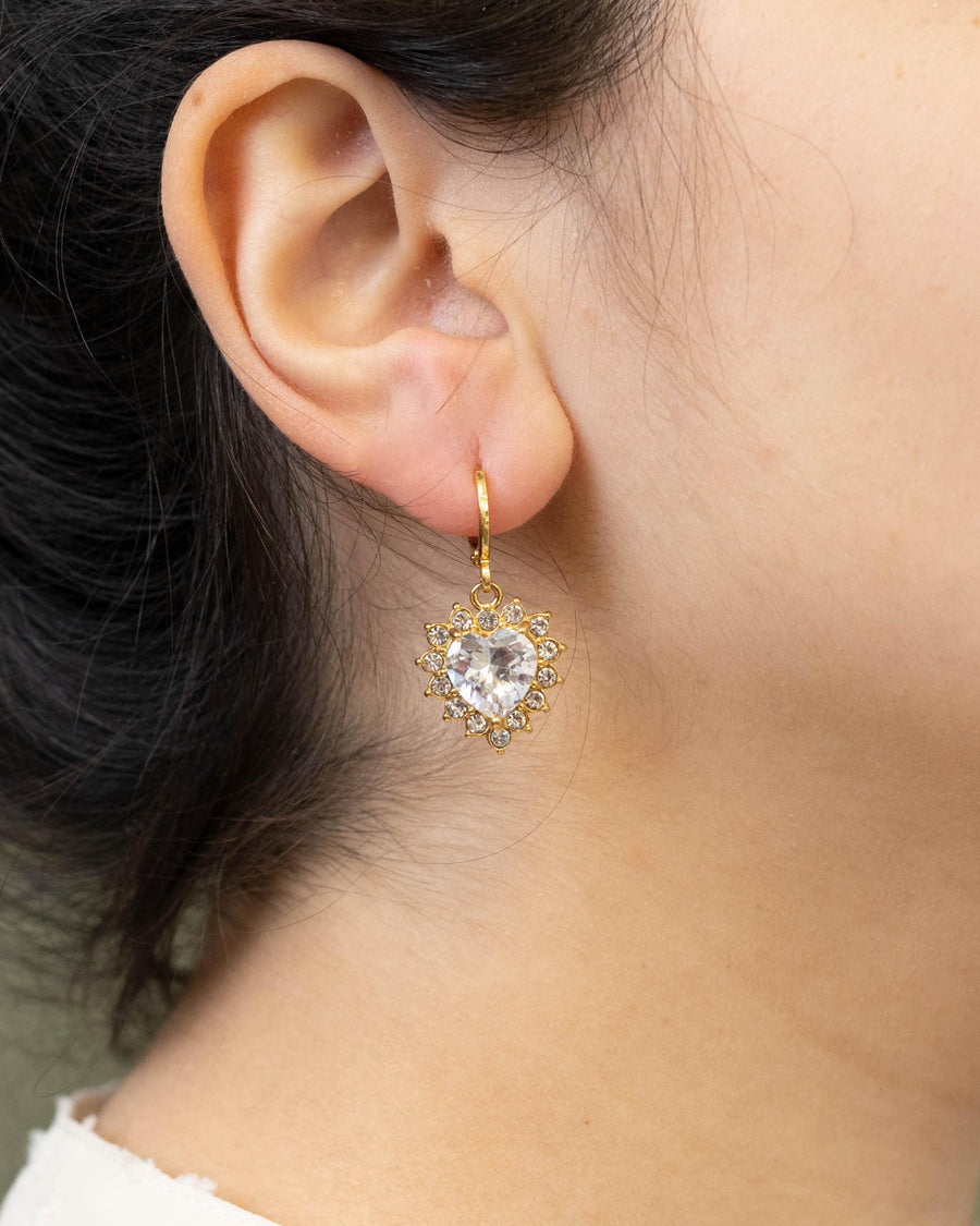 Style Image - Queen Heart earring worn on ear, featuring a heart-shaped halo design with shimmering crystals and 18k gold plated stainless steel setting