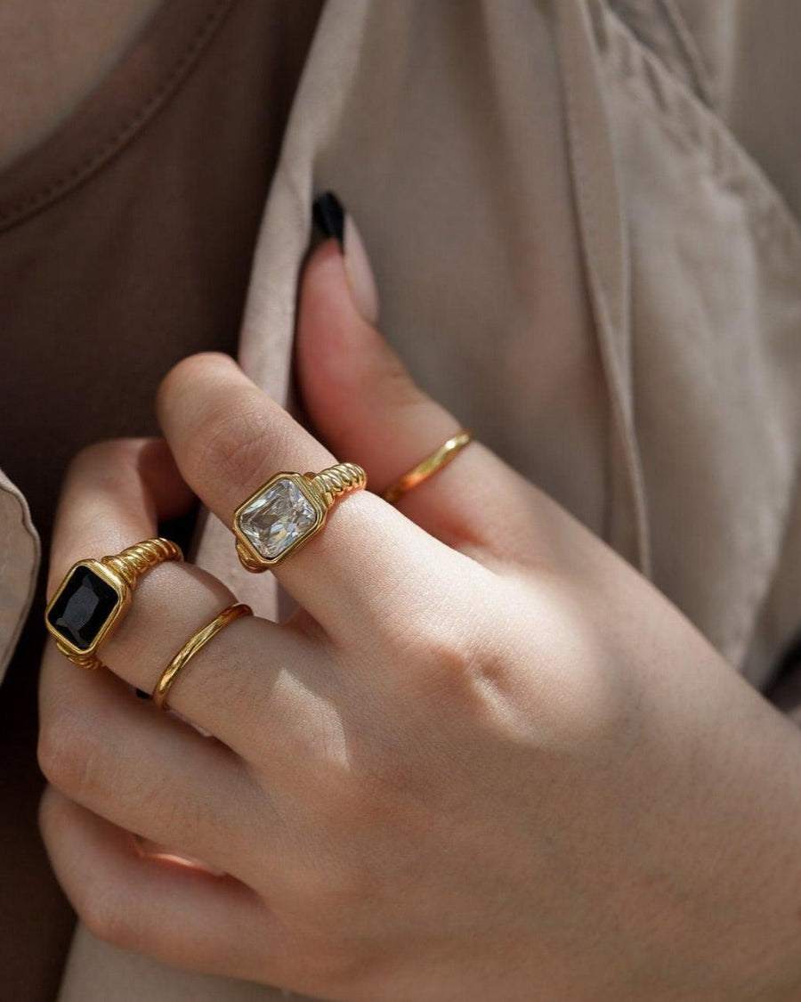 Model Image - Twisted Signet Ring in black with a twisted band detail styled on the hand alongside other rings worn on model