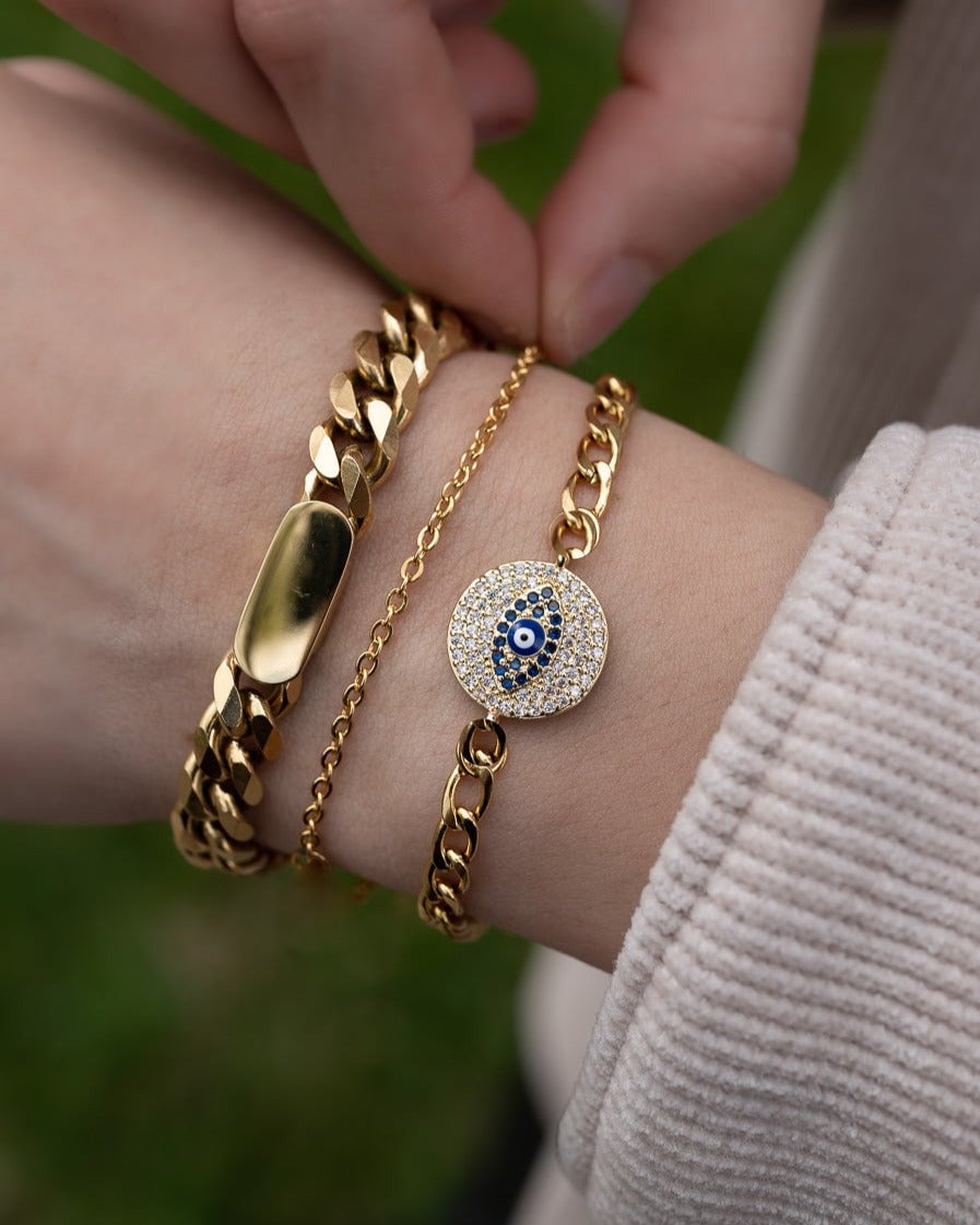 Model Image - Dainty gold plated cable chain bracelet styled on the wrist with layered bracelets worn on model