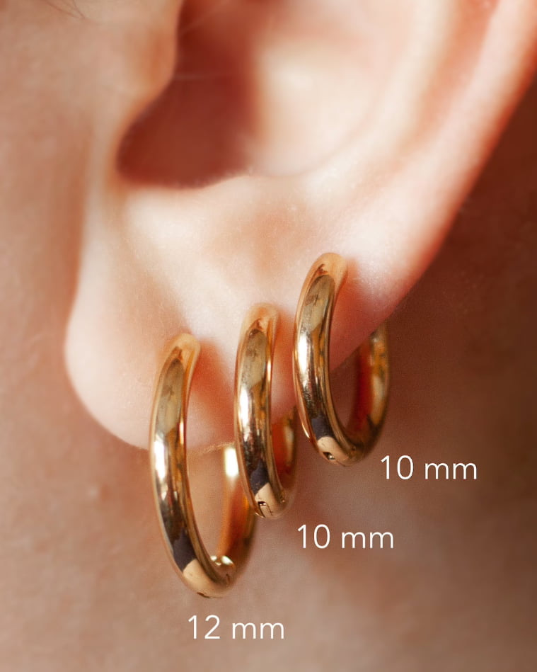 Model Image - Simple 10mm hoop earrings styled on the ear with other hoop sizes for scale worn on model