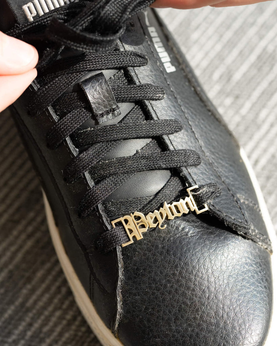 Style Image - Customizable shoe lace charm with name detail worn on a black sneaker lace