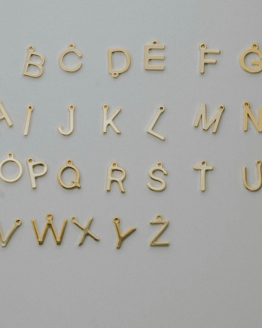 Initial charms arranged alphabetically for the layering necklace set
