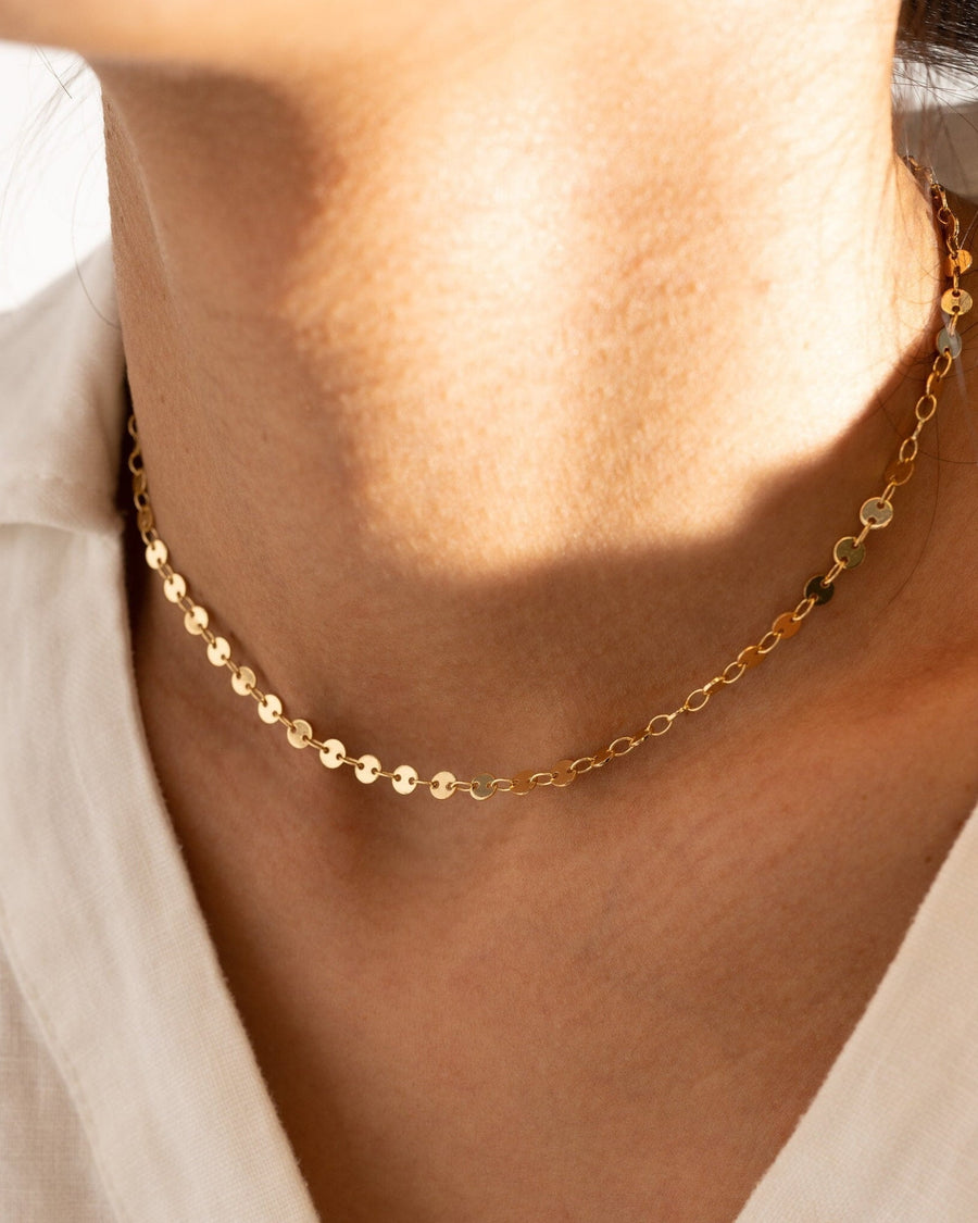 Model Image - gold plated disc chain necklace styled close to the neckline worn on model