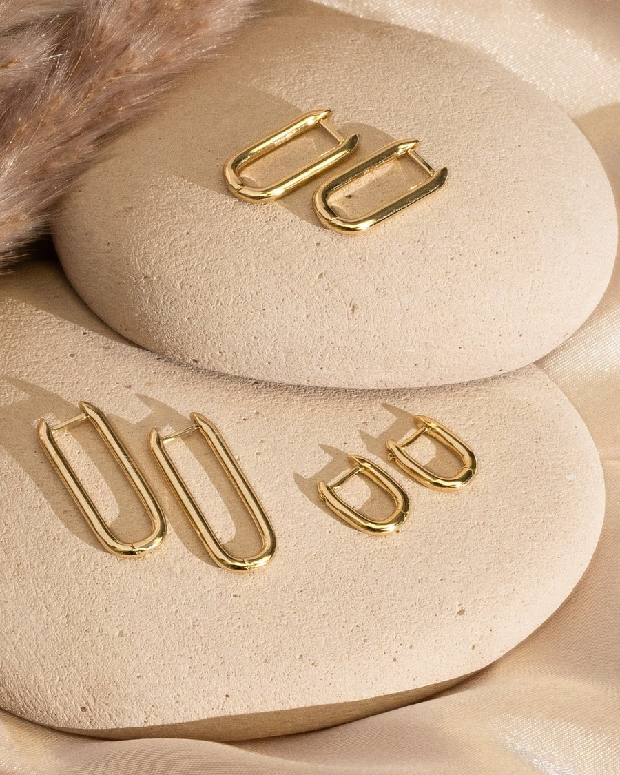 Detail Image - 14K gold plated U shaped earrings arranged in 12mm, 20mm, and 25mm sizes on neutral stone displays
