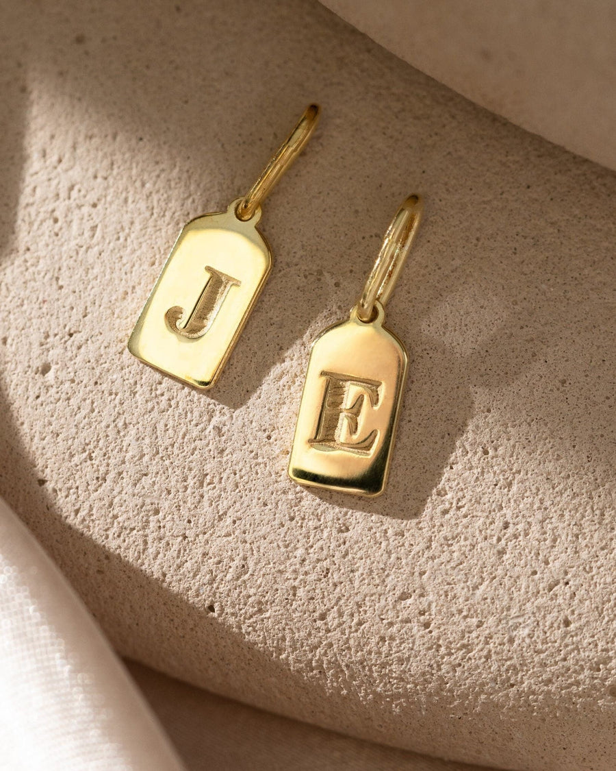 Model Image - initial tag charm necklace with small letter pendant worn on model