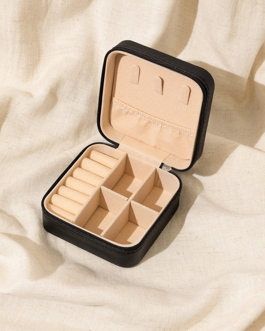 Detail Image - Open black vegan leather jewelry travel case with ring rolls and divided storage compartments for small jewelry pieces