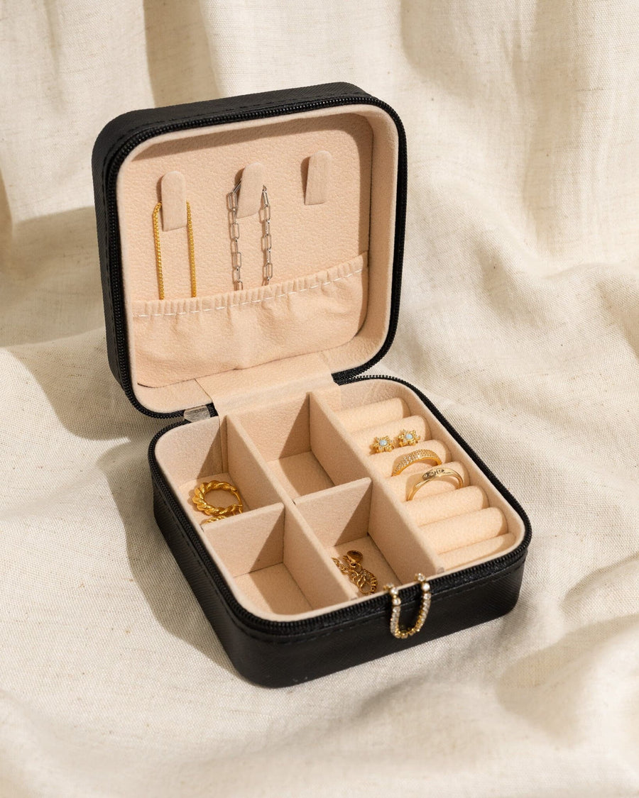 Detail Image - Open black vegan leather jewelry travel case with compartments for earrings, necklaces, bracelets, and rings
