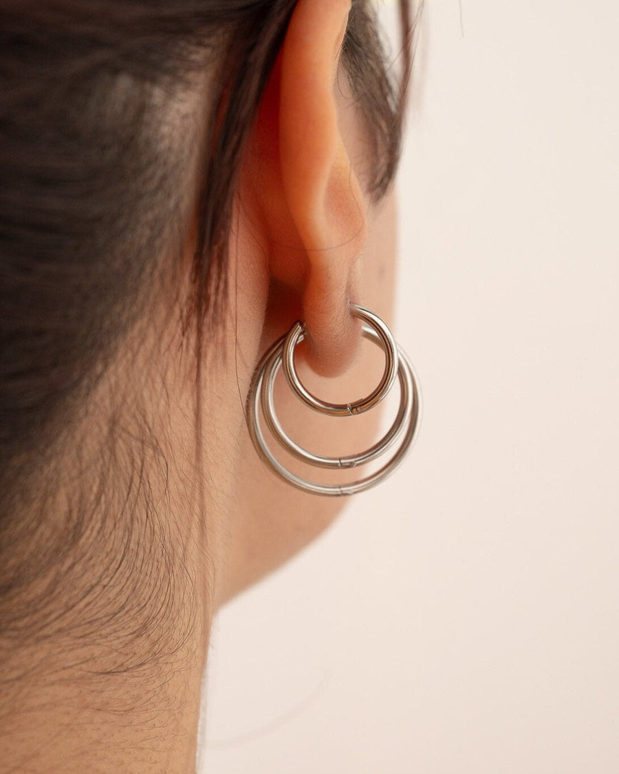 Style Image - Gold plated hoop earrings worn together on the ear in multiple sizes.