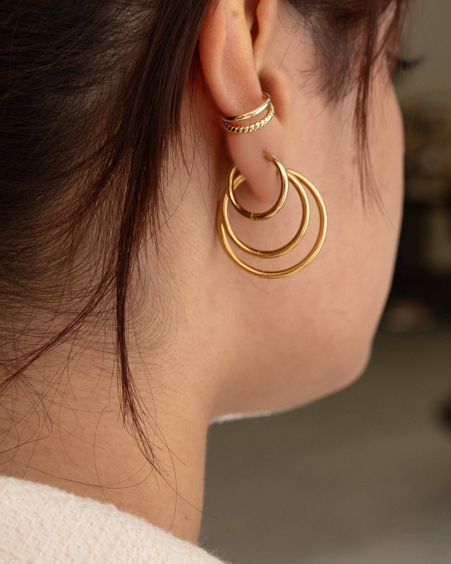 Style Image - Gold plated hoop earrings worn stacked in small, medium, and large sizes on the ear