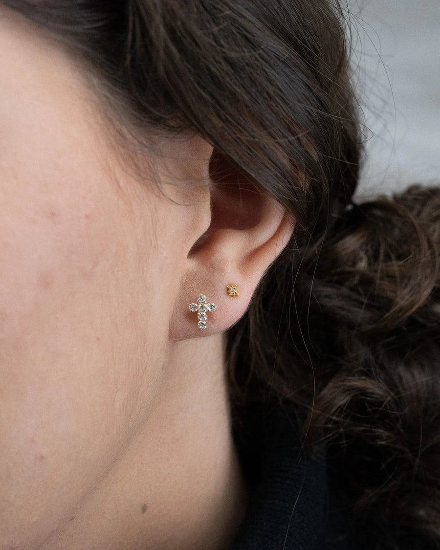 Style Image - Paved cross stud earring worn with a small gold plated stud in a layered ear look