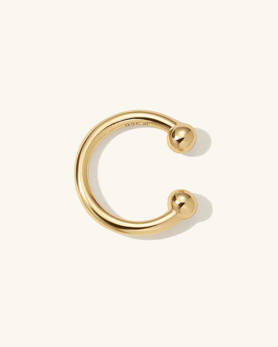Detail Image - Plain 14K gold plated ear cuff with rounded open ends on a neutral background