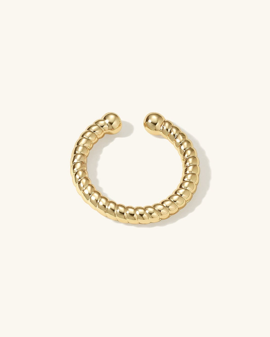 Detail Image - Twisted 14K gold plated ear cuff with rounded open ends on a light background