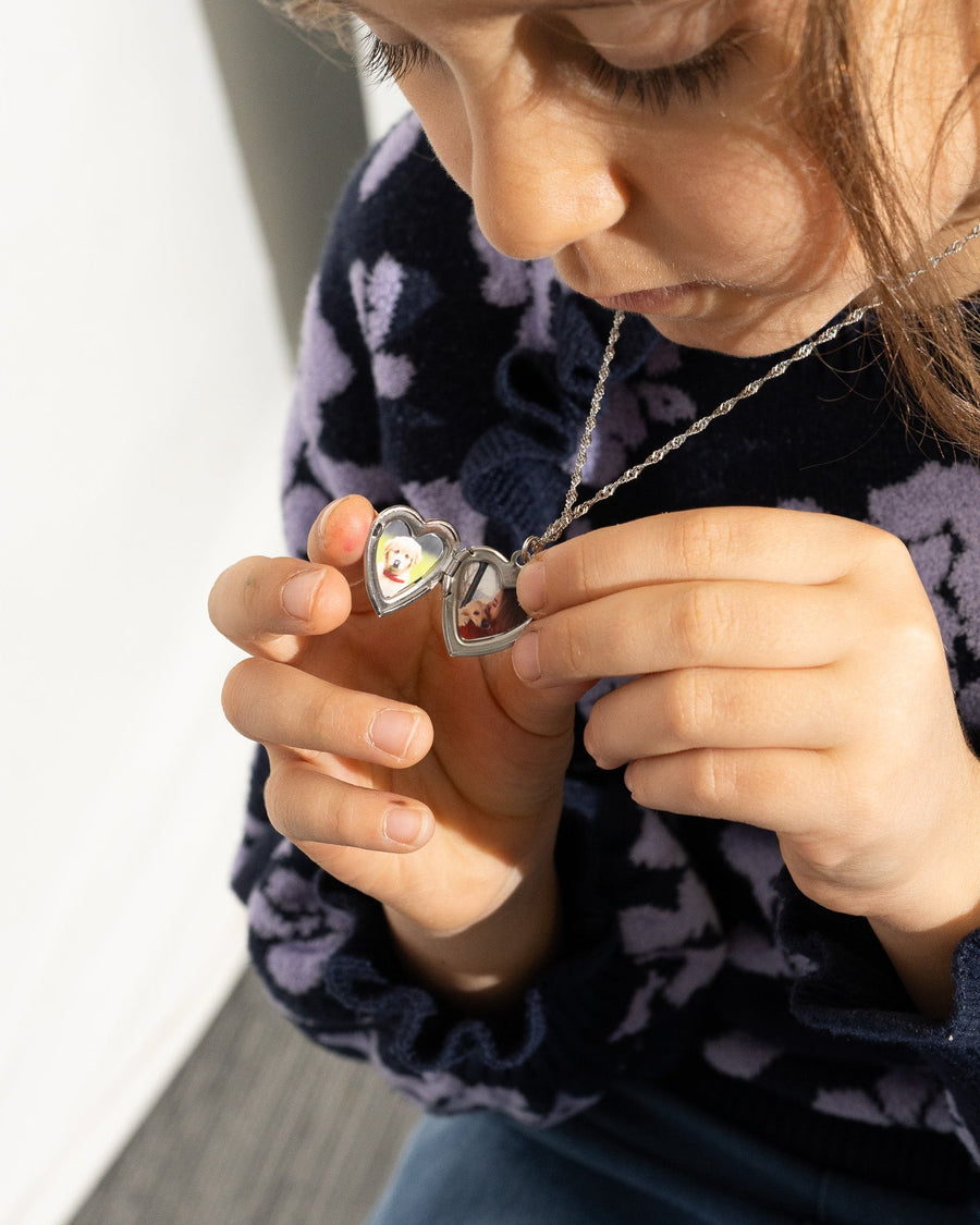 Open heart locket necklace with photo personalization held in hand