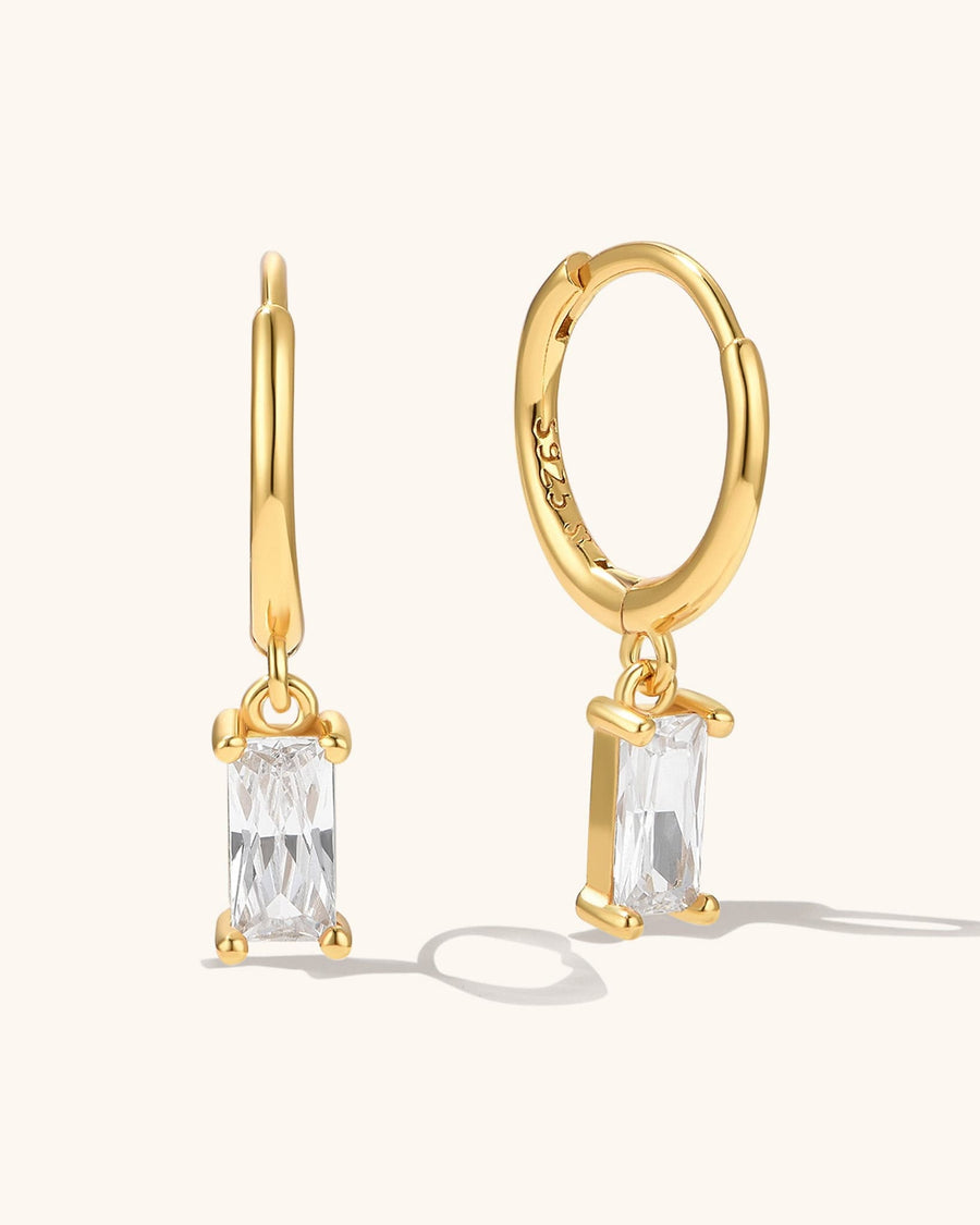 Model Image - 14K gold plated zircon earrings with rectangular clear stones shown on the ear worn on model