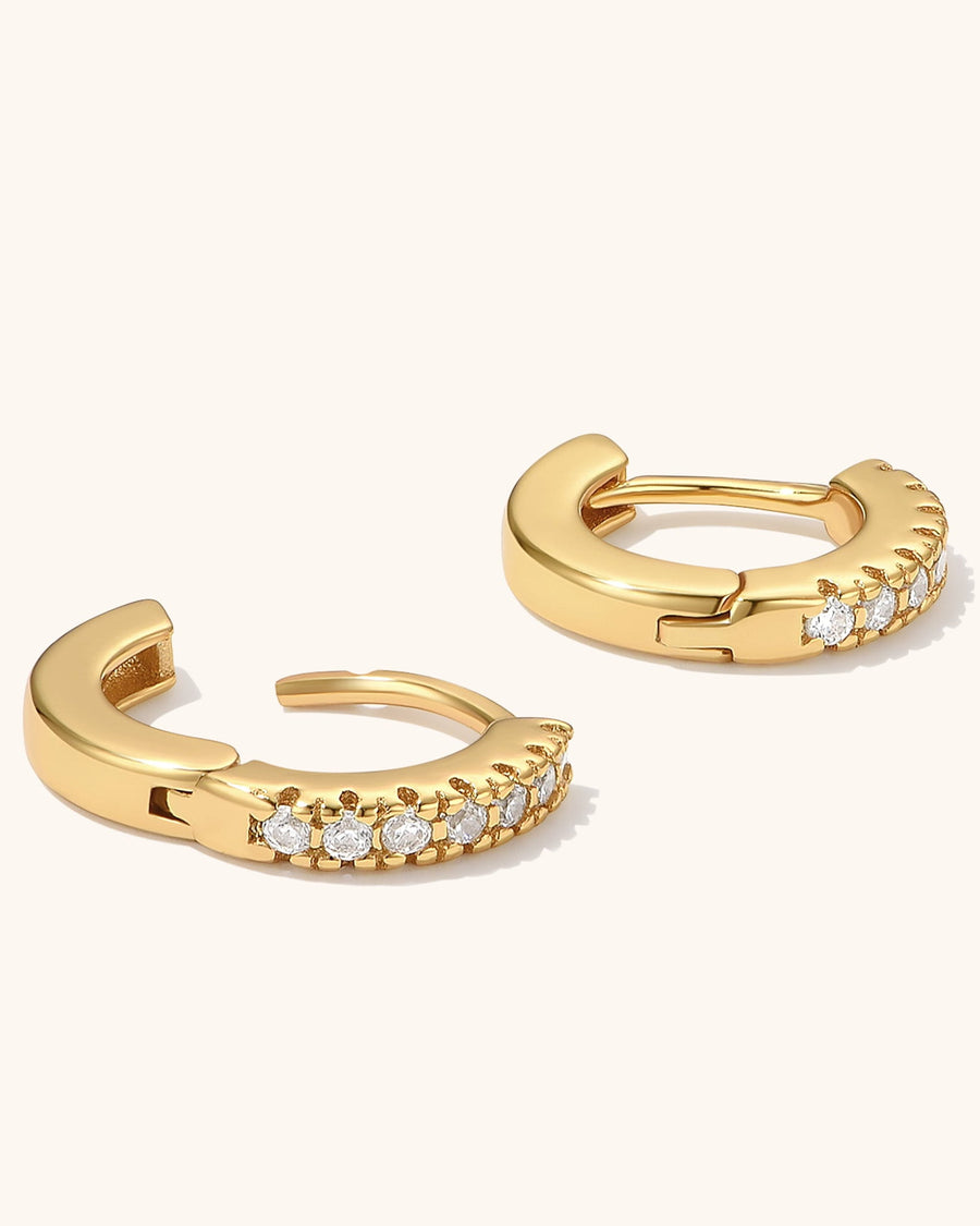 Detail Image - 14K gold plated cubic zirconia huggie hoops shown open with curved clasp design