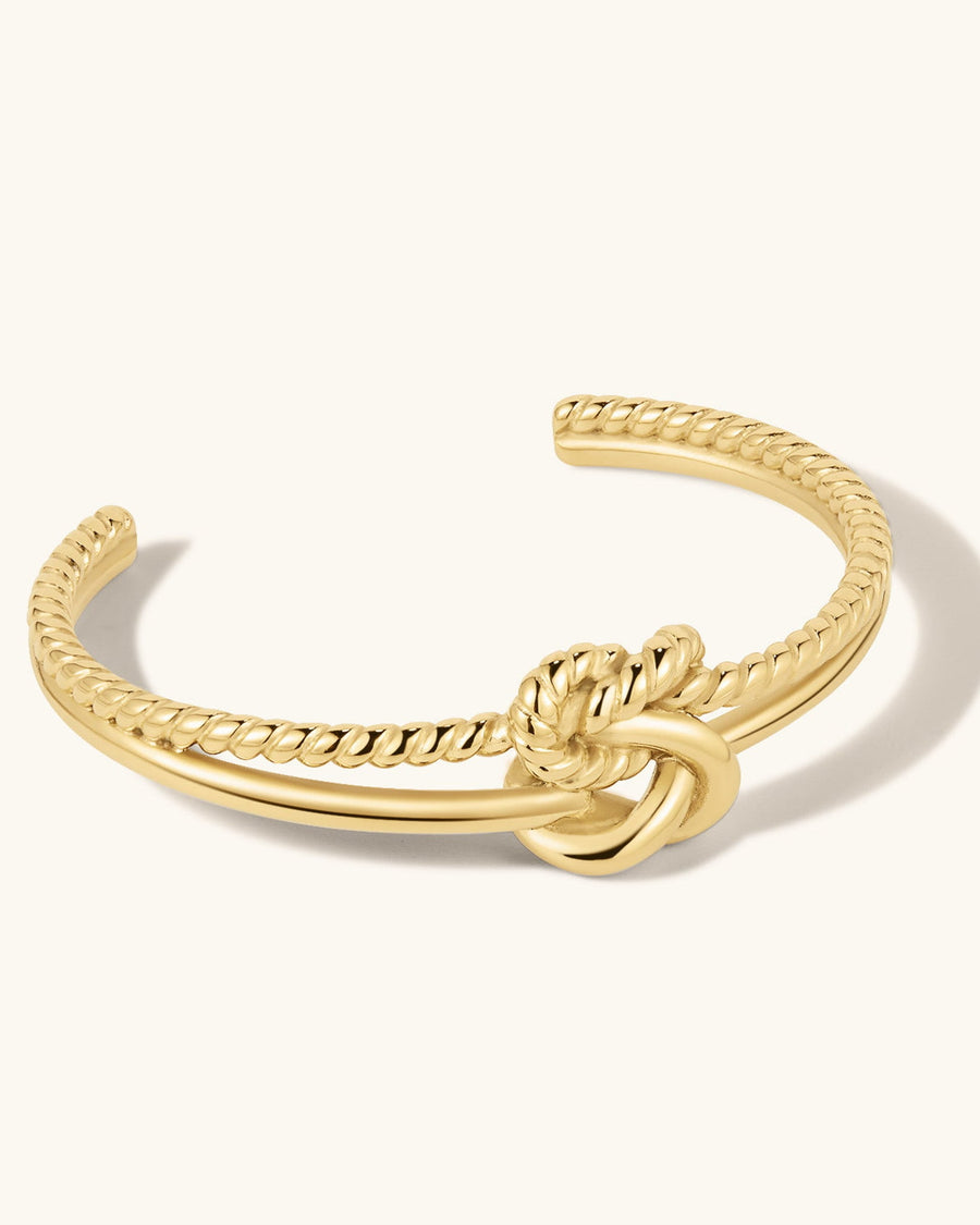Detail Image - Knot Cuff Bracelet in 18k gold plated stainless steel with a rope-textured cuff and central knot design