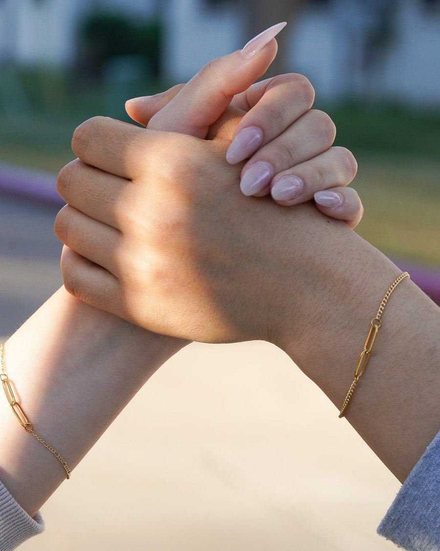Style Image - Couple Baby Curb Bracelets in 18k gold plated stainless steel worn on two wrists with hands clasped
