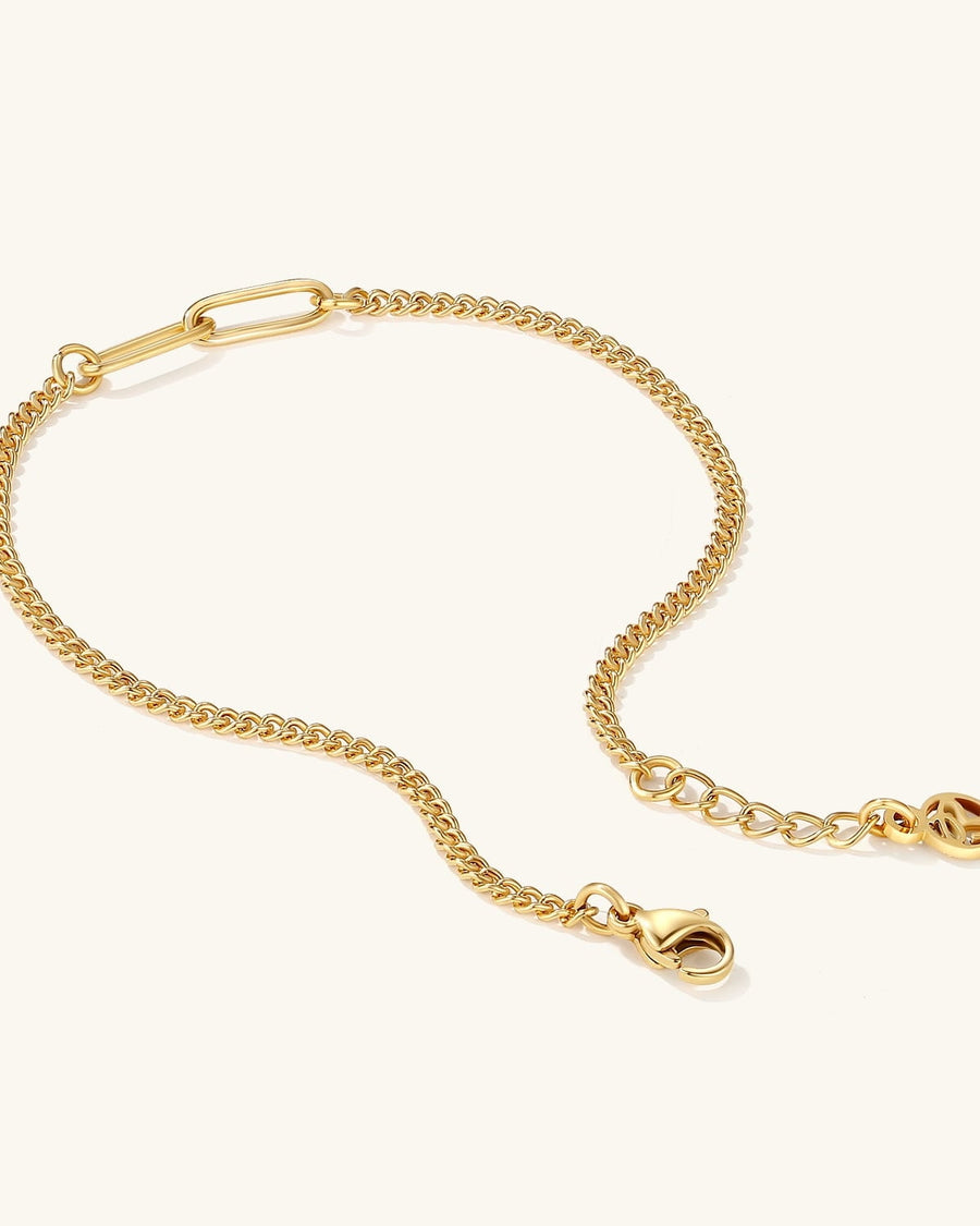 Detail Image - 18k gold plated stainless steel baby curb bracelet with clasp and extender chain on a light background