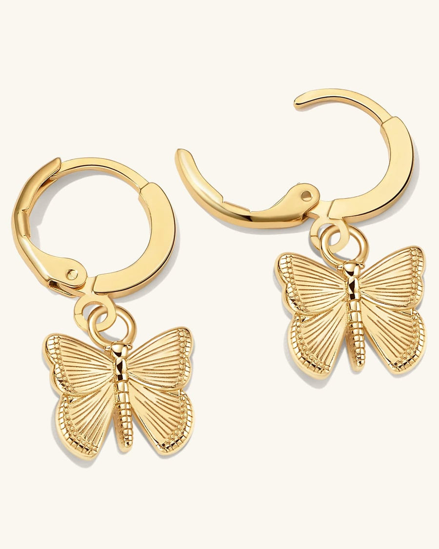 Detail Image - Dainty 14K gold plated hoop earrings with textured butterfly charms on a light background