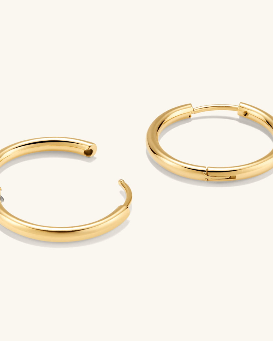 Detail Image - Gold plated hoop earrings shown open to highlight the clasp design.