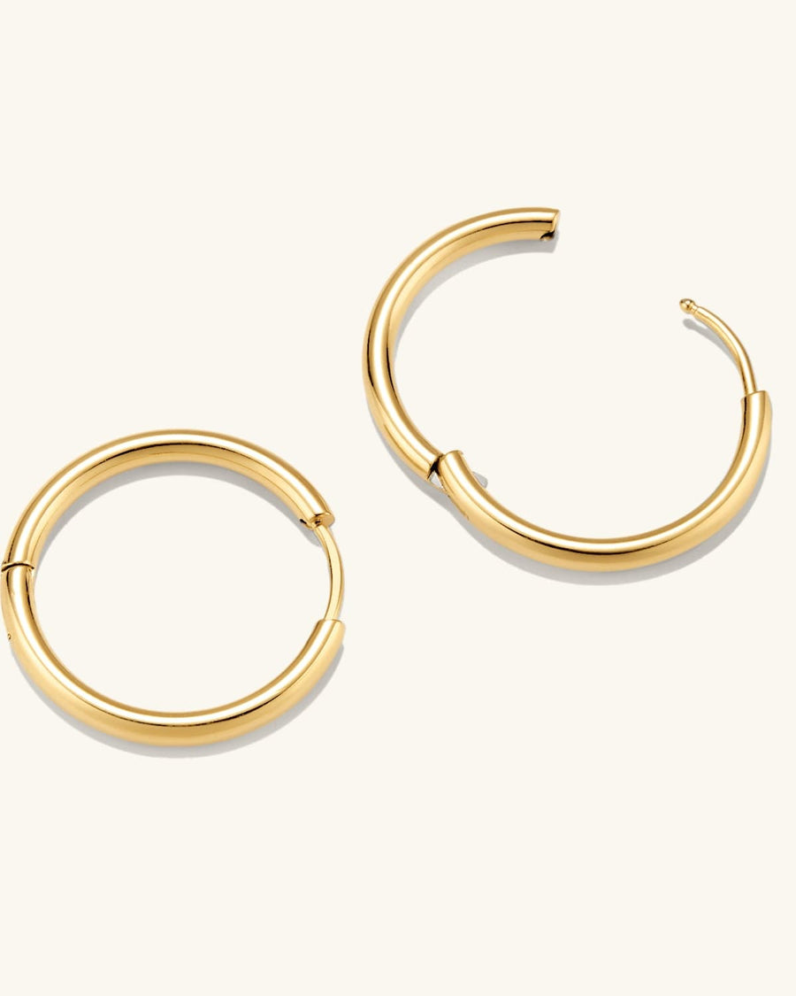 Detail Image - 14K gold plated hoop earrings shown open and closed with slim rounded profiles.