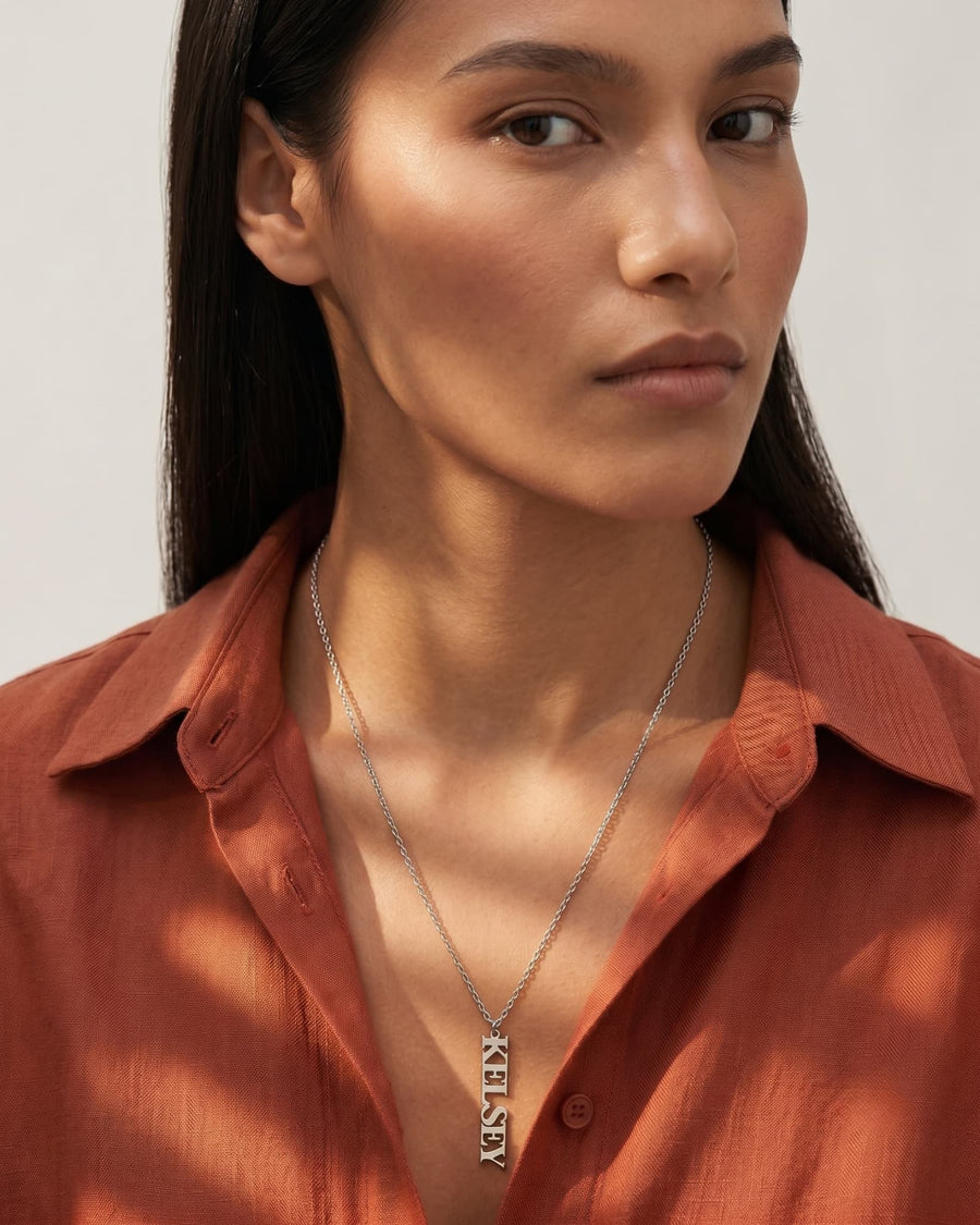 Model Image - Vertical name necklace with slim personalized name plate worn on a chain