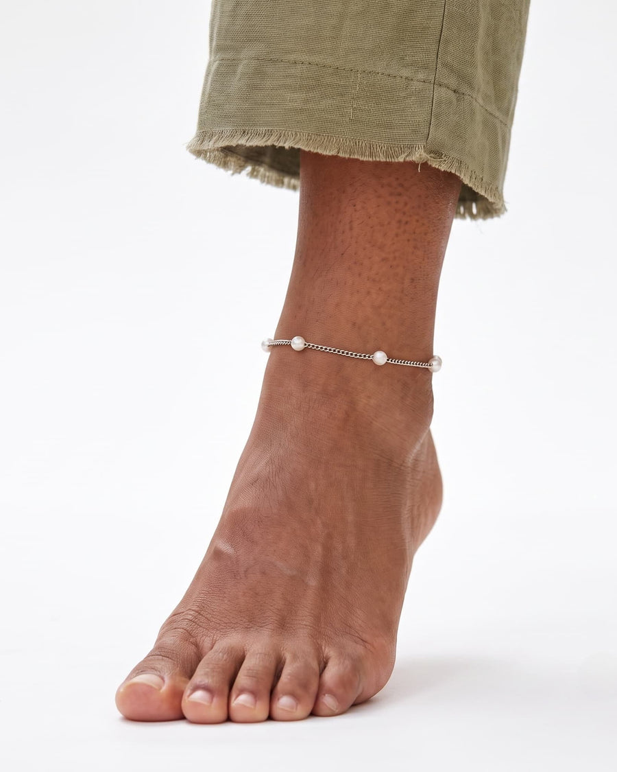 Model Image - Stainless steel satellite pearl chain anklet with spaced 4mm pearl beads around the ankle worn on model