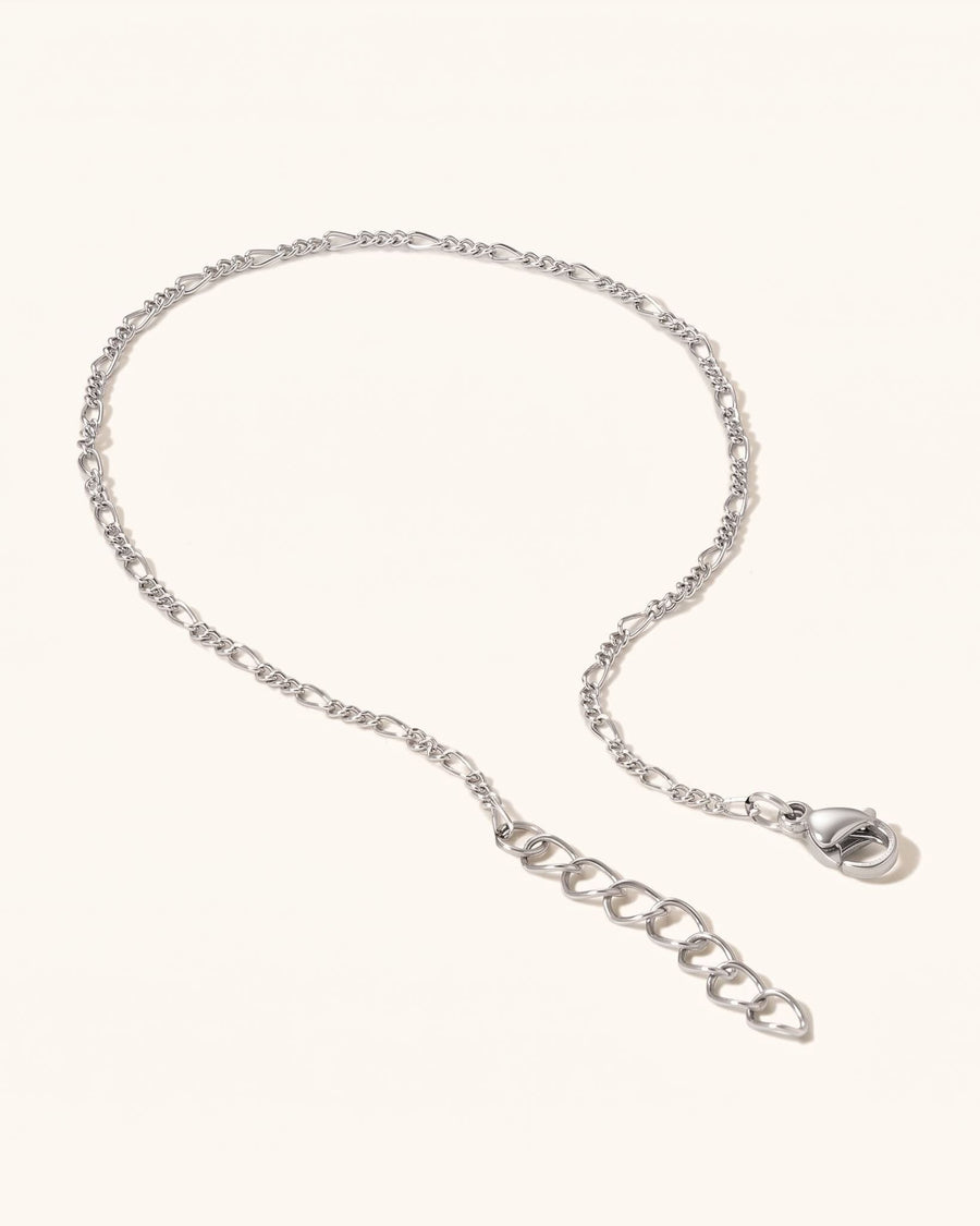 Detail Image - Rhodium Figaro anklet with 3 mm chain, clasp, and extender laid flat on a light background.