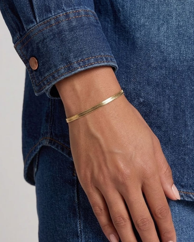 Style Image - 18k gold herringbone bracelet worn on the wrist with a flat, reflective chain pattern.