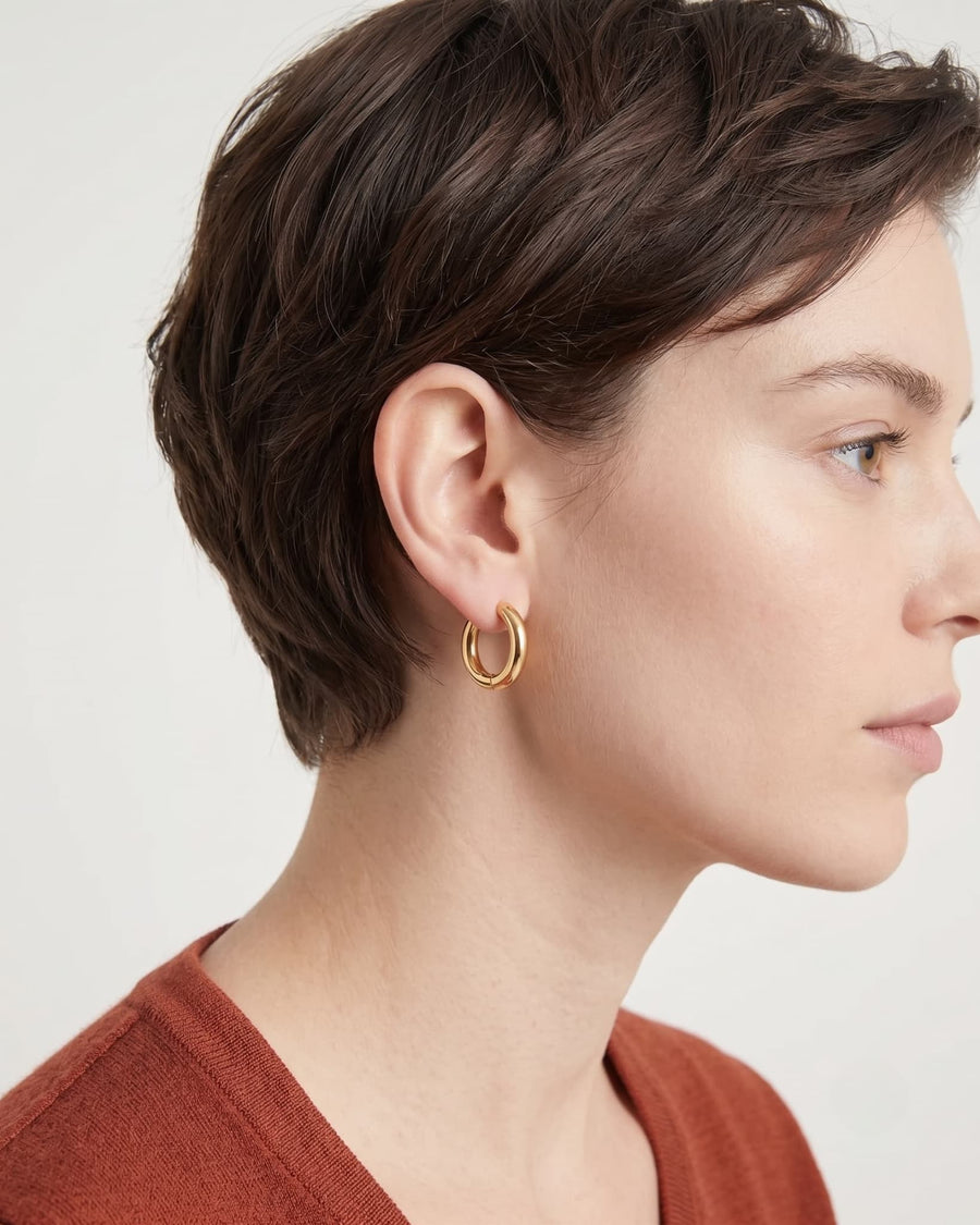 Model Image - 18k gold 12mm simple hoop earring shown on the ear in a close side profile worn on model