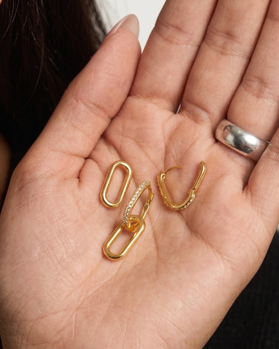 Detail Image - 14K gold Pave Link Hoops held in hand, showing interlocking link design and pave sparkle